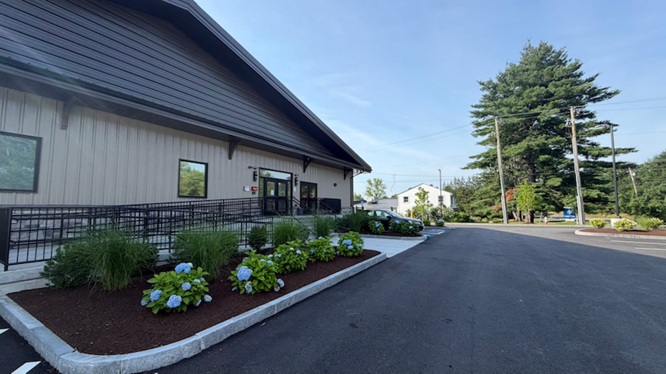 Finished mulched planting beds and shrubs around a commercial building