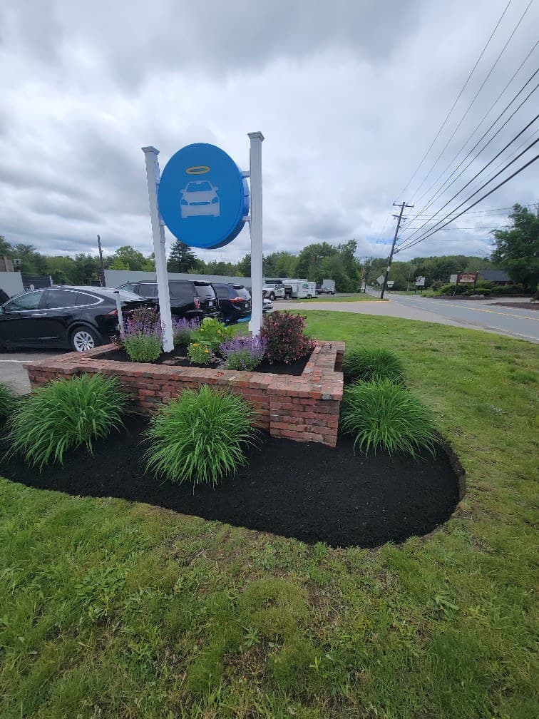 Mulched planting bed around a commercial property sign