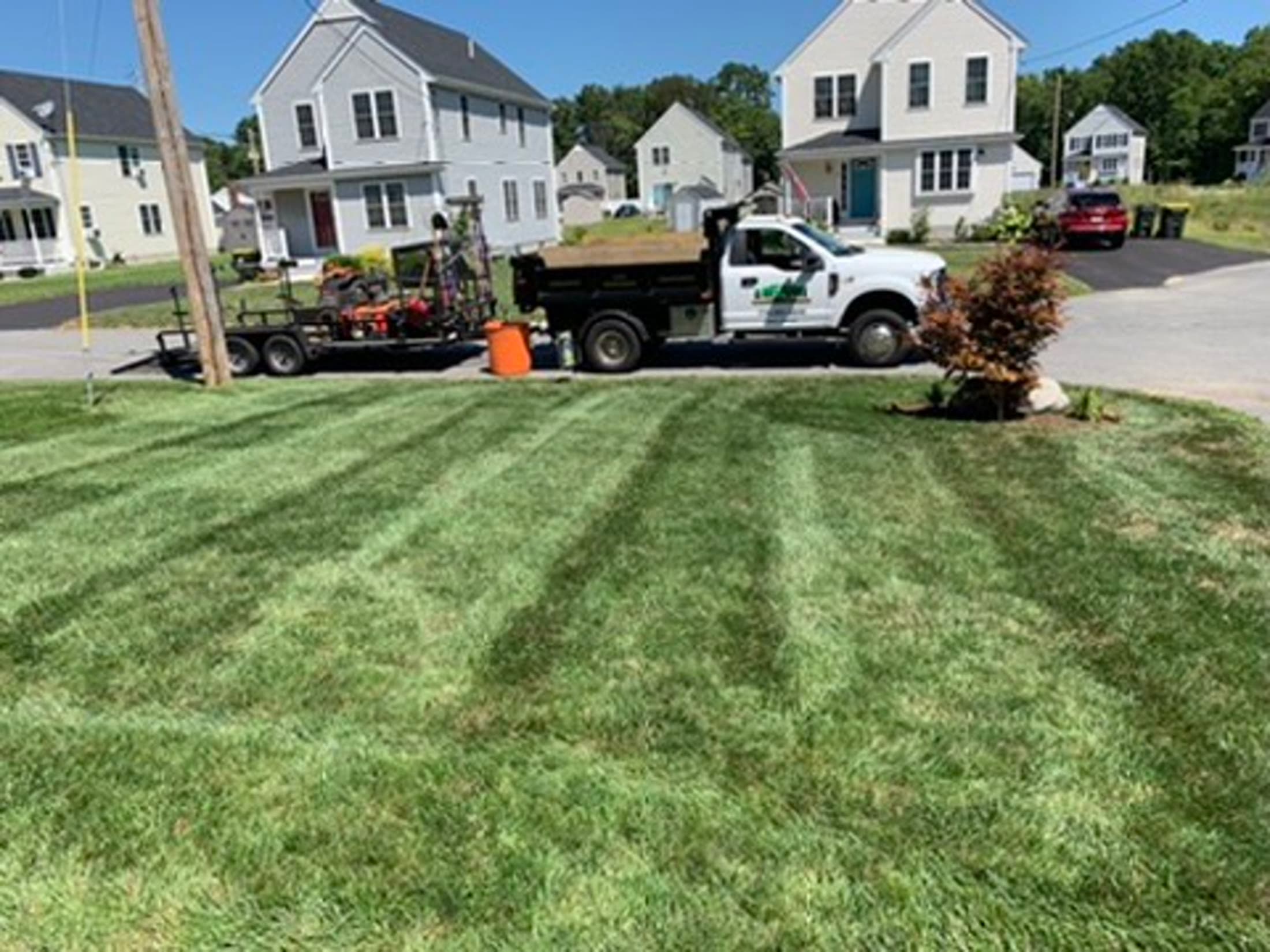Landscape maintenance crew with trucks and equipment ready for service