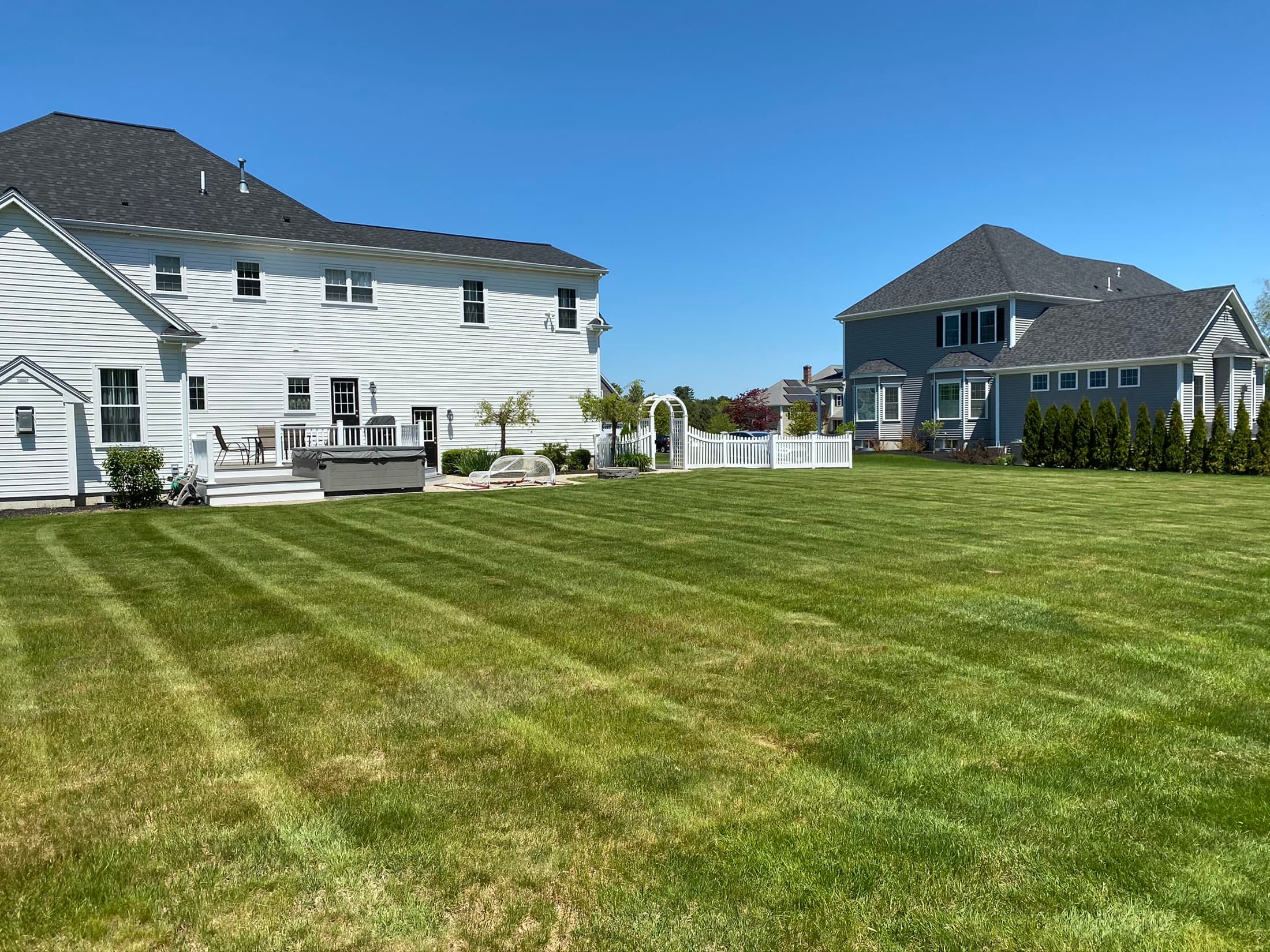 Large residential property with a freshly manicured green lawn