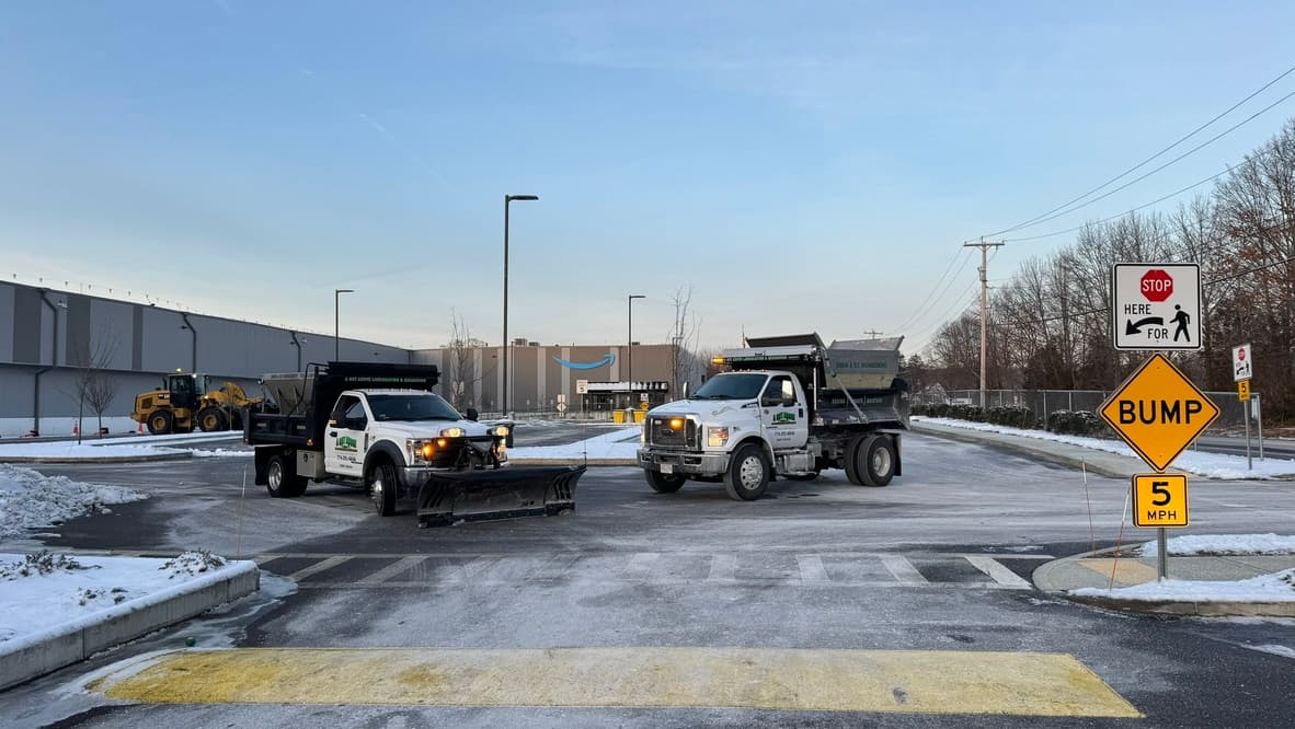 A Cut Above plow and salting trucks staged on a cleared commercial property