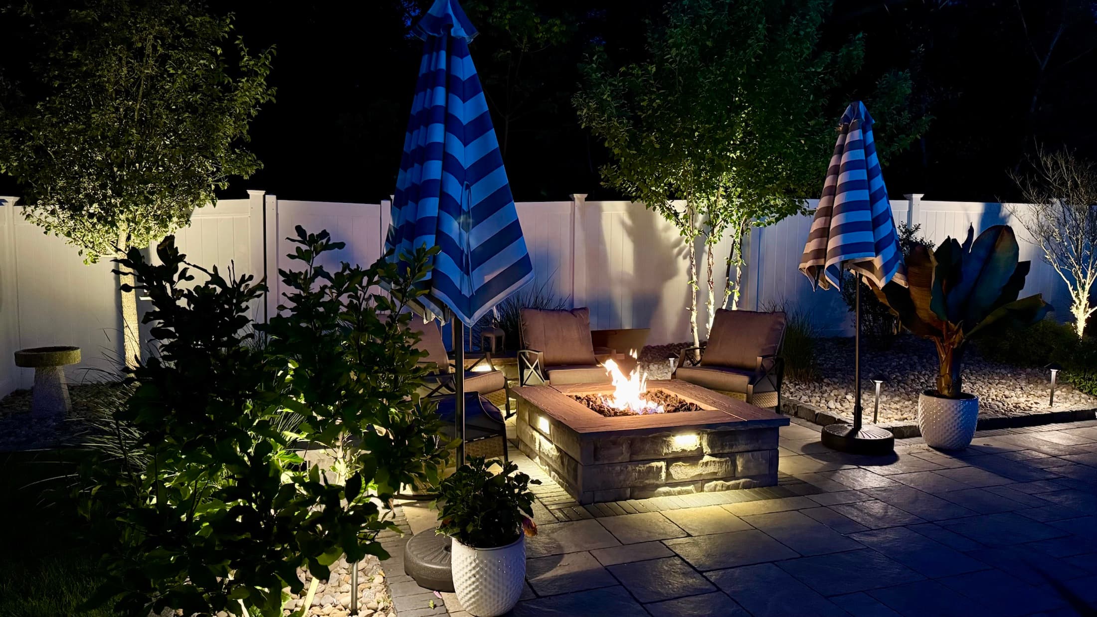 Illuminated paver patio and fire pit installed by A Cut Above