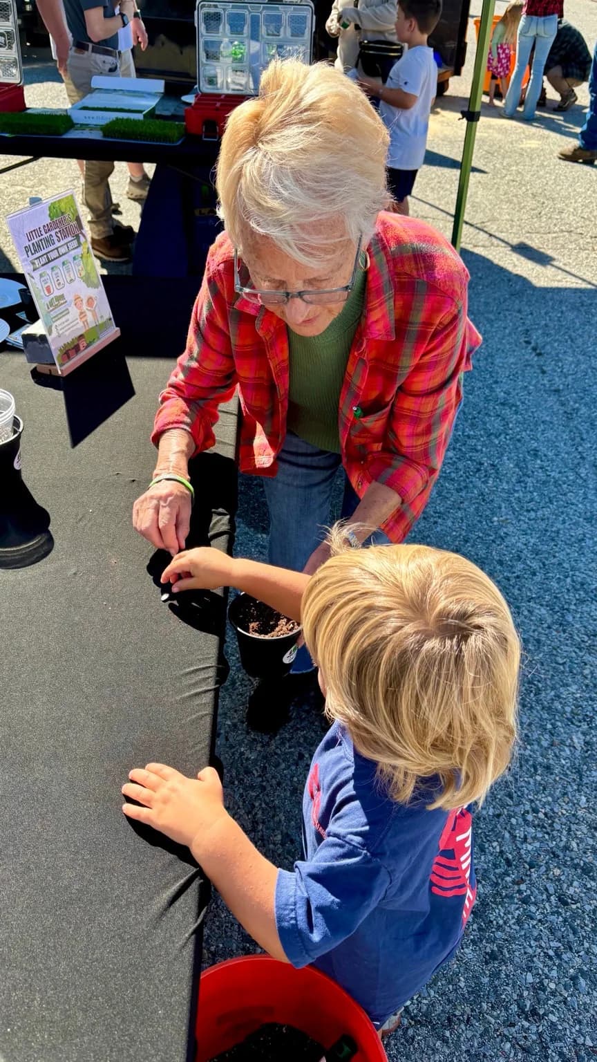 Planting seeds together at A Cut Above's Little Gardener's station during The Morgan Mission Touch-a-Truck