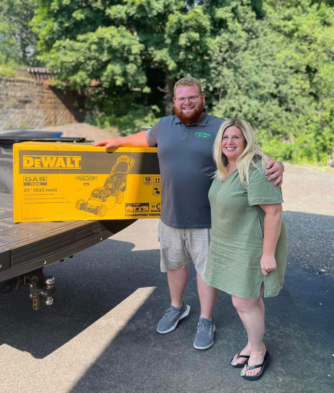A Cut Above presenting a donated lawn mower to Pawfect Life Rescue