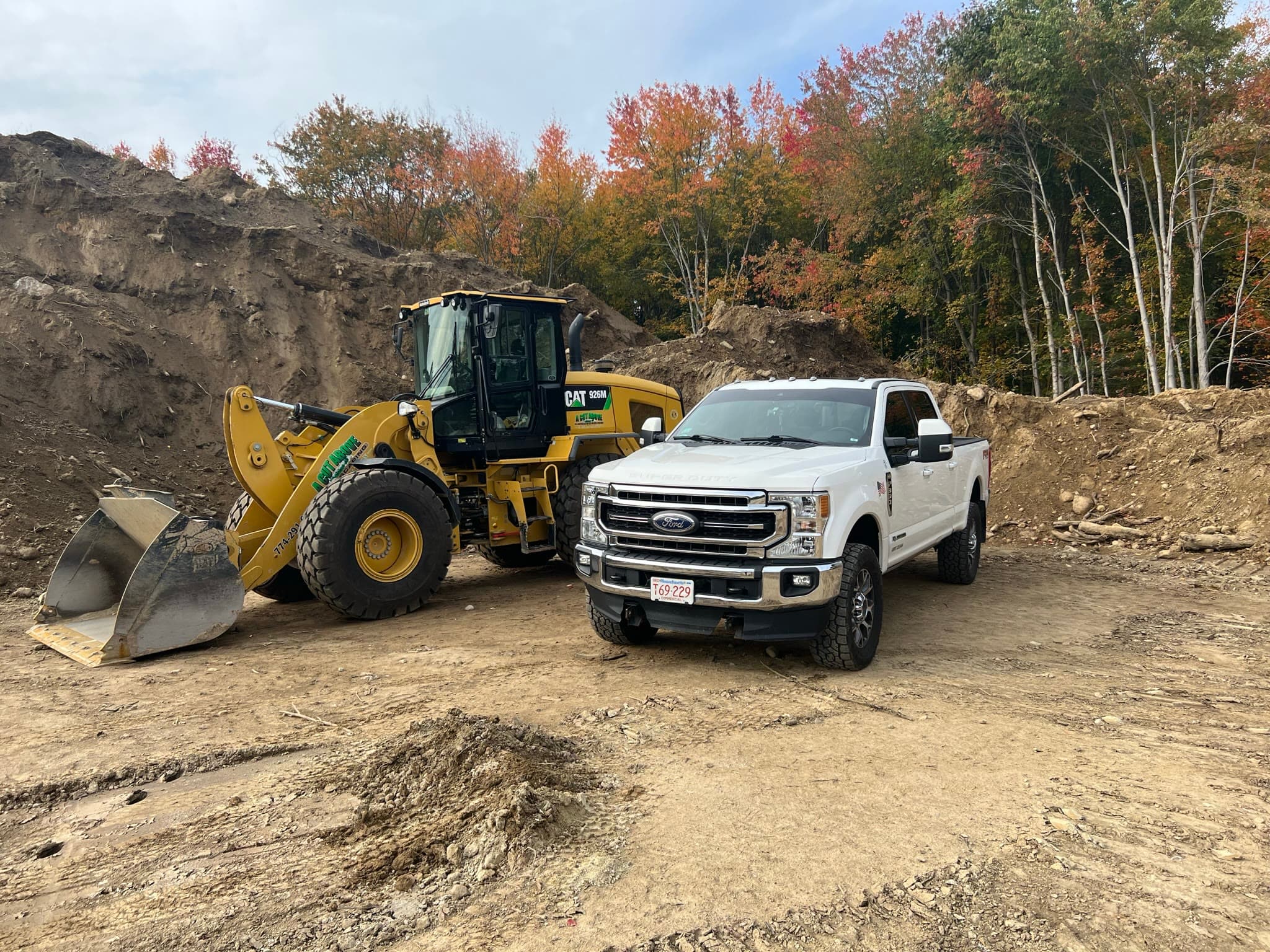 Loader and work truck on an active excavation site