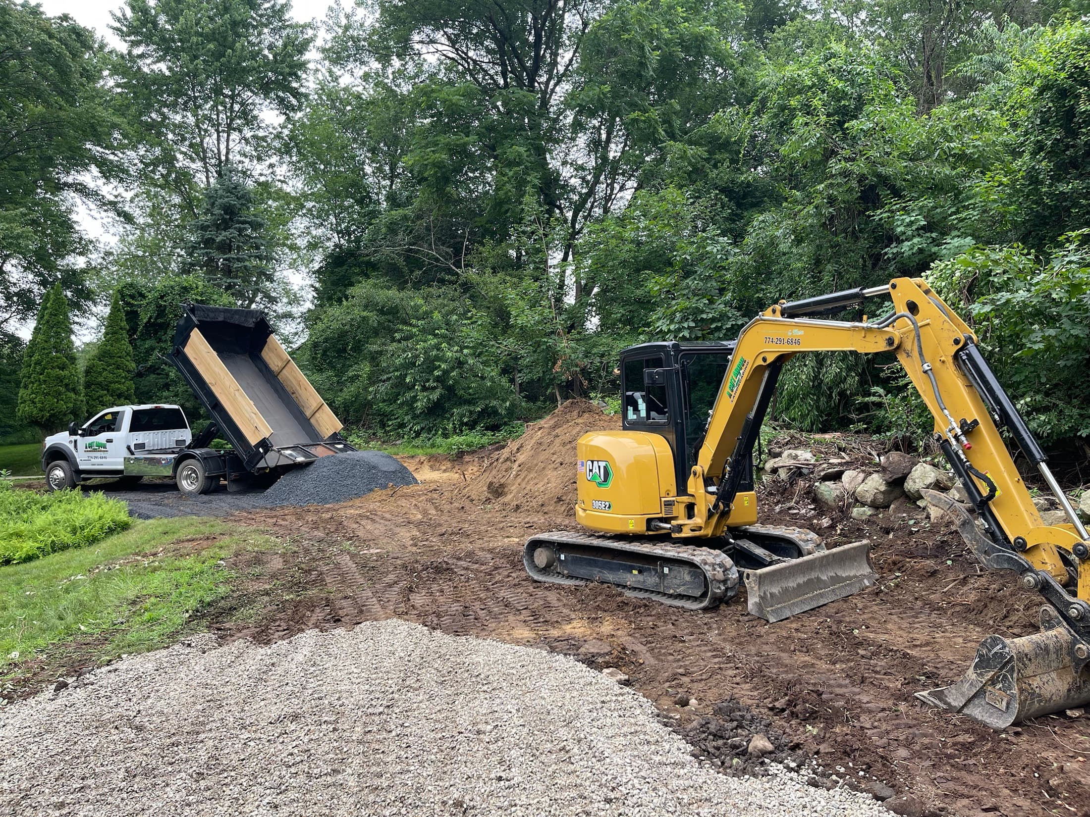 A Cut Above excavator and dump truck preparing a residential site